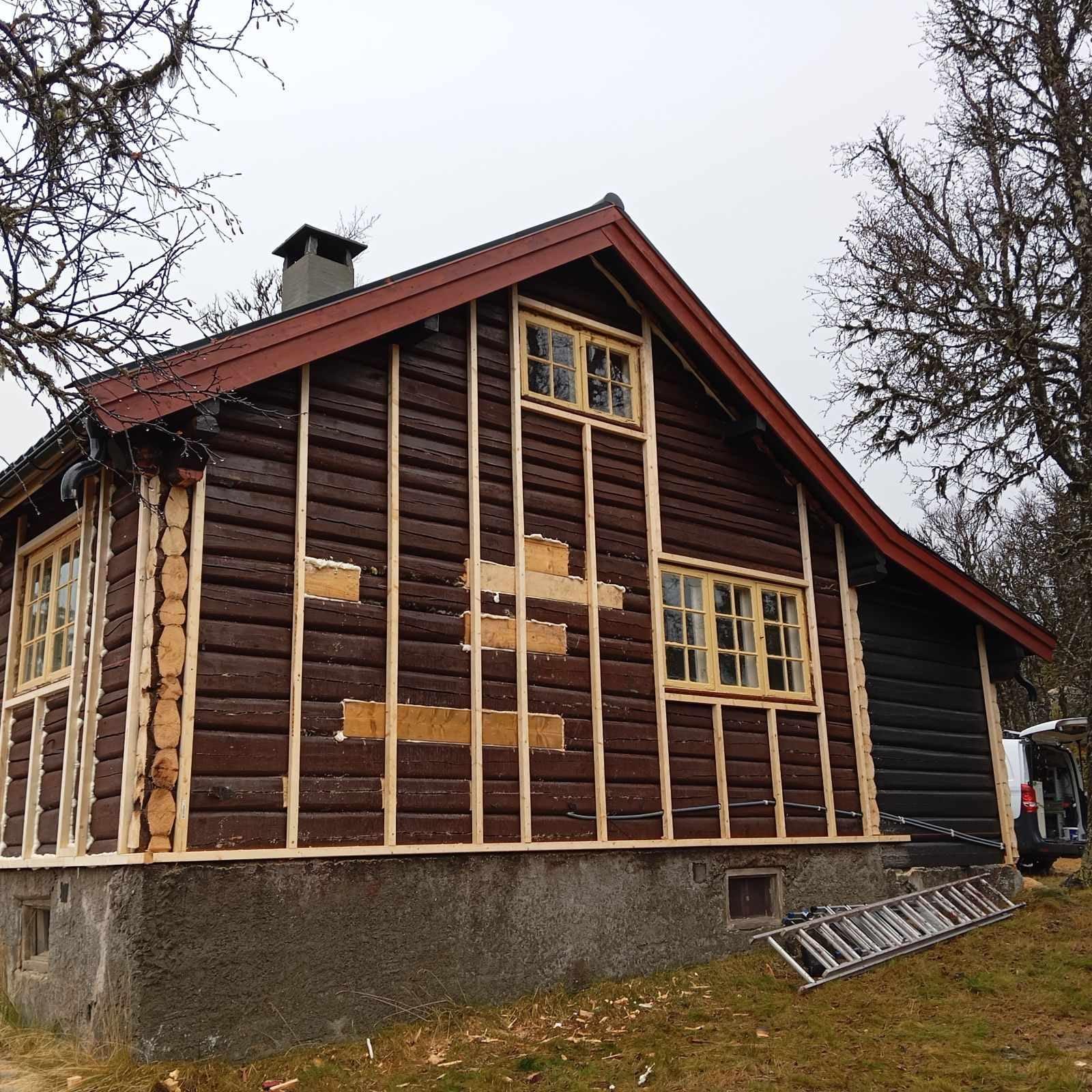 A log house with new battens fixed over the old walls